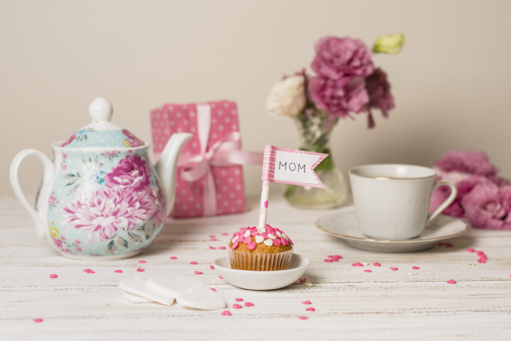 delicioso-pastel-bandera-decorativa-titulo-mama-cerca-tetera-flores-taza